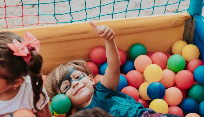 girl in blue shirt lying on yellow inflatable pool