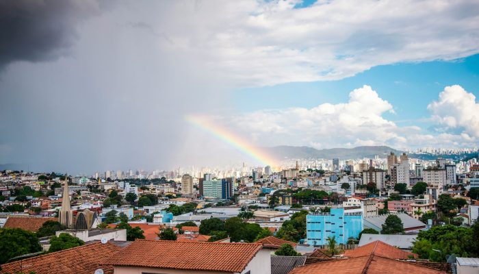 a rainbow in the sky over a city