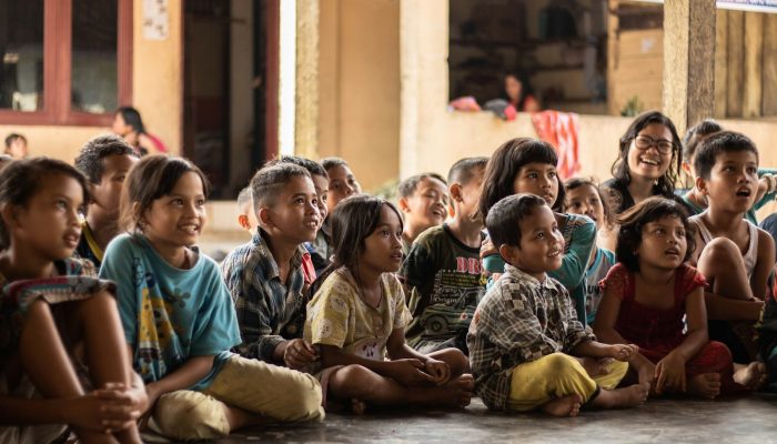 group of childrens sitting on ground